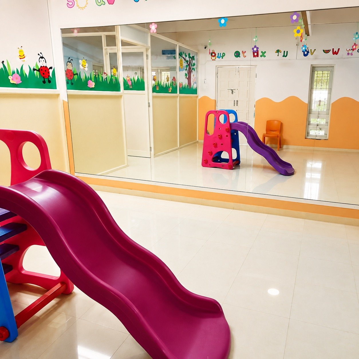 Indoor play area with a slide and climbing toy