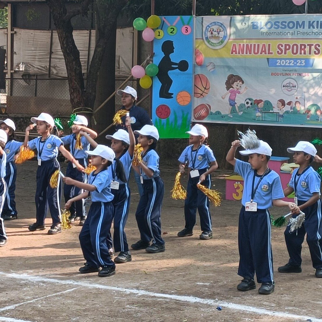 Blossom Kids International Preschool students cheering with pom-poms at their annual sports day